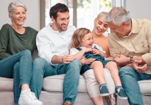 Smiling family of all ages looking down at camera representing whole-family healthcare at Forest Lake Family Practice